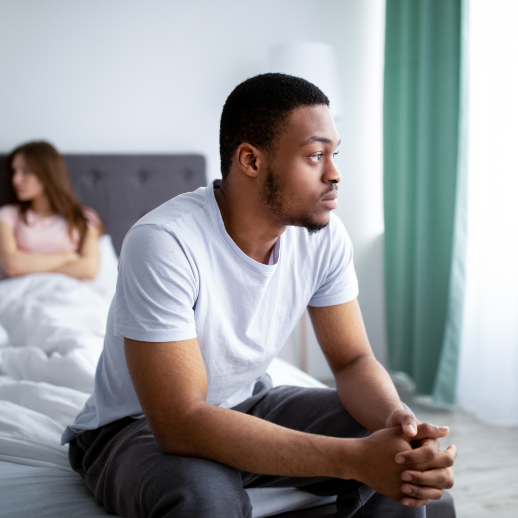man sitting on bed with relationship might be struggling