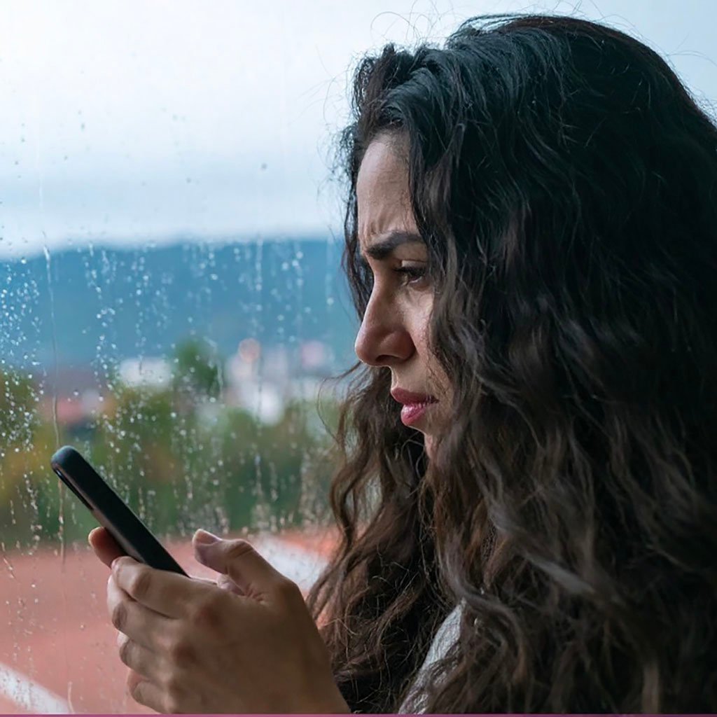 Women looking at her phone overthinking