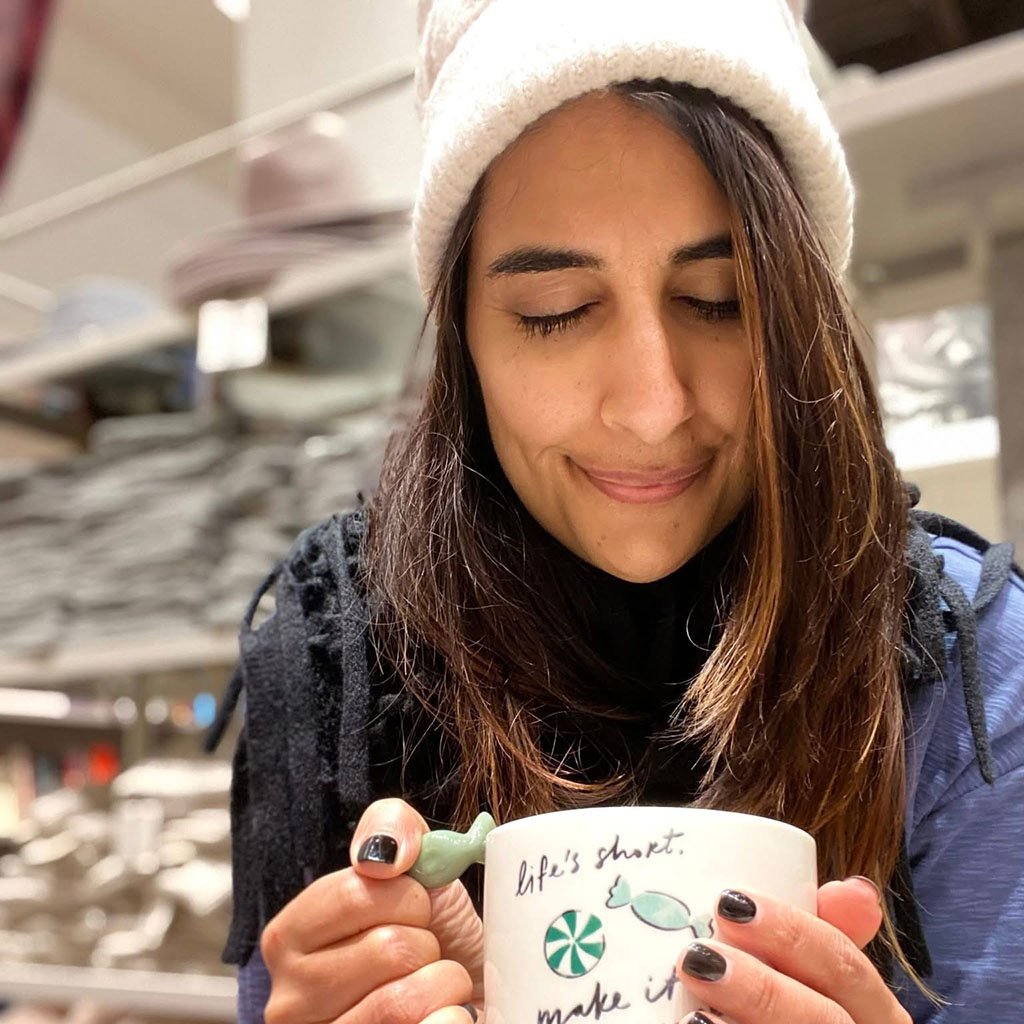Bravezone CEO Nadia holding a coffee mug while being mindful.