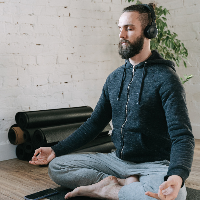 Person meditating with headphones on.